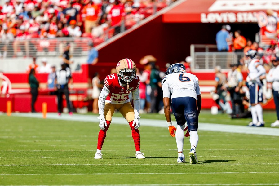 Jack Jones in a red 49ers home uniform lines up across from a Denver receiver at Levi's Stadium in Week 4.