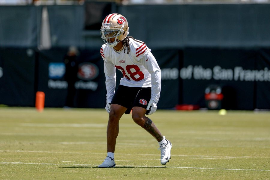 Jalen Stroman, No. 38, in a white 49ers practice jersey and gold helmet, crouched and turning to cover on a practice field in Santa Clara. A club gallery photograph from an offseason practice, not from Las Vegas.