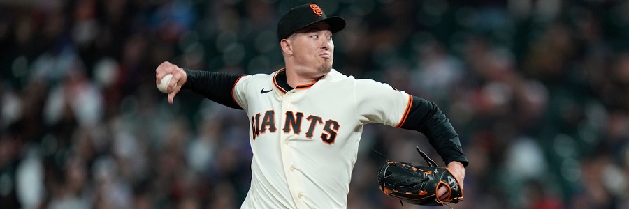 Blade Tidwell in mid-delivery in San Francisco's cream home uniform, GIANTS in black and orange across the chest and an SF cap, the ball in his bare right hand behind his head and his glove out in front of him.