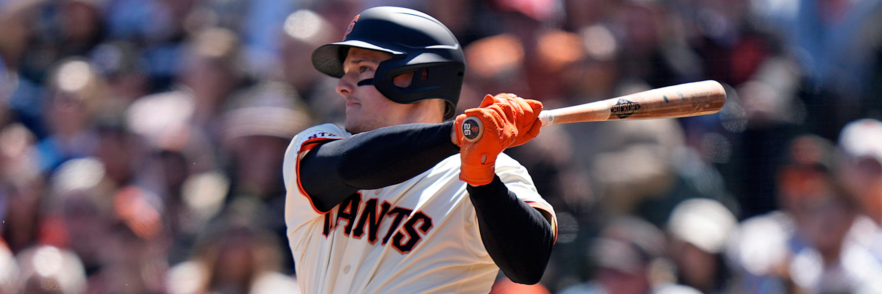 Matt Chapman follows through on a swing in the Giants' cream home uniform, his number 26 visible on the knob of the bat.