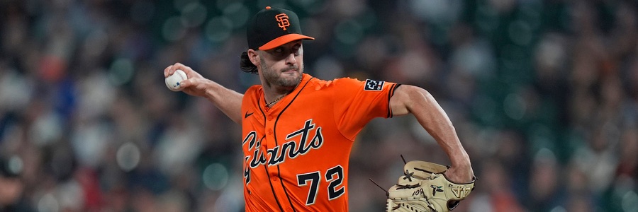 Trevor McDonald mid-delivery for the Giants in the orange alternate jersey, number 72, his throwing arm extended and the ball visible in his right hand. It is the elbow of that arm, rebuilt on August 5, that opened the 40-man roster spot this piece is about.