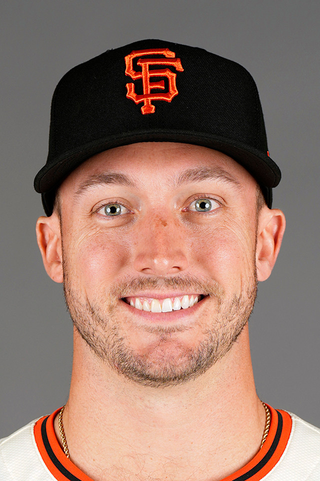 Andrew Knizner in a posed club portrait, wearing a black cap with the orange interlocking SF mark and a cream jersey with black and orange collar piping
