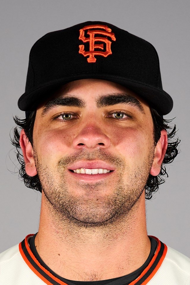 Marcelo Mayer in a black San Francisco Giants cap with the orange interlocking SF, over a cream home jersey with orange and black piping. It is the league's current headshot for him. He has not played a game in the uniform.