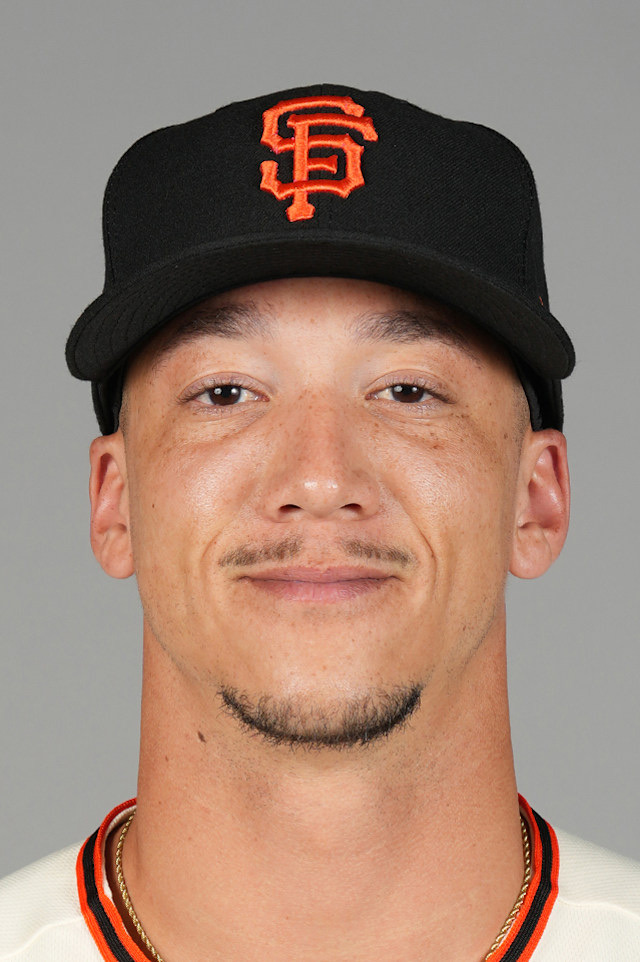 Spencer Bivens in a posed head-and-shoulders portrait against a plain grey background, wearing a black San Francisco Giants cap and a cream home jersey. A league media headshot, not from a game.