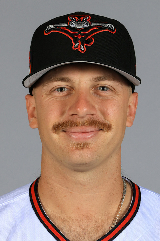 Zach Morgan in a posed minor league headshot taken before his call-up, wearing a white jersey with black and orange collar piping under a black cap carrying an orange and white cartoon animal mark. It is not the San Francisco uniform.