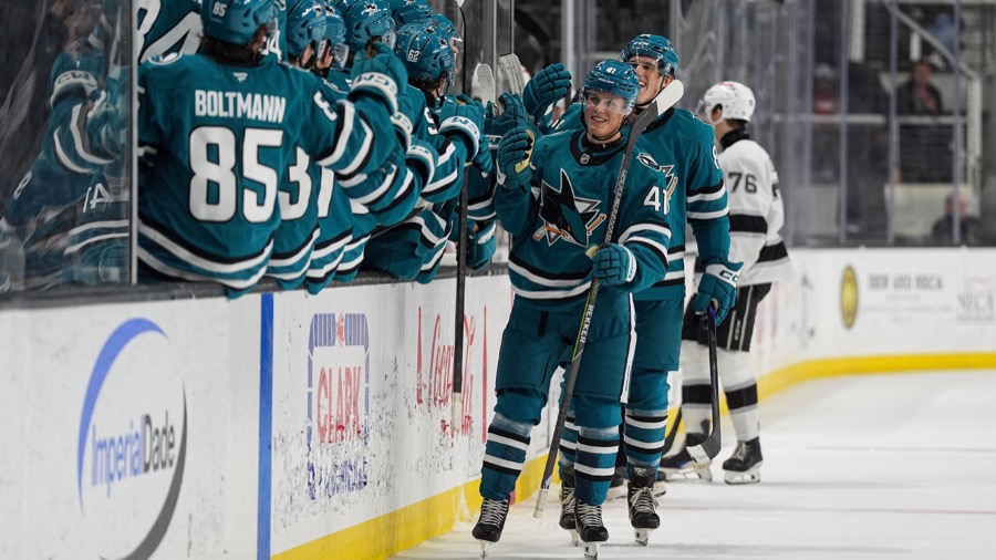 Ivar Stenberg, in a Sharks game sweater, celebrates with teammates at the bench after a goal against the Los Angeles Kings at the Rookie Faceoff in San Jose on September 12, 2026. Not from the Vegas game.