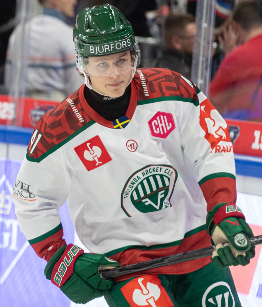 Ivar Stenberg in Frolunda's white road sweater and green helmet, warming up before a Champions Hockey League game against Eisbaren Berlin in October 2025. He has not yet played a game for San Jose, so no photograph of him in a Sharks sweater exists.