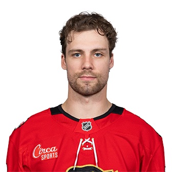 Nolan Allan in a head-and-shoulders portrait, wearing the red home sweater of the Chicago Blackhawks with black and white shoulder stripes, photographed against a white background before his trade to San Jose.